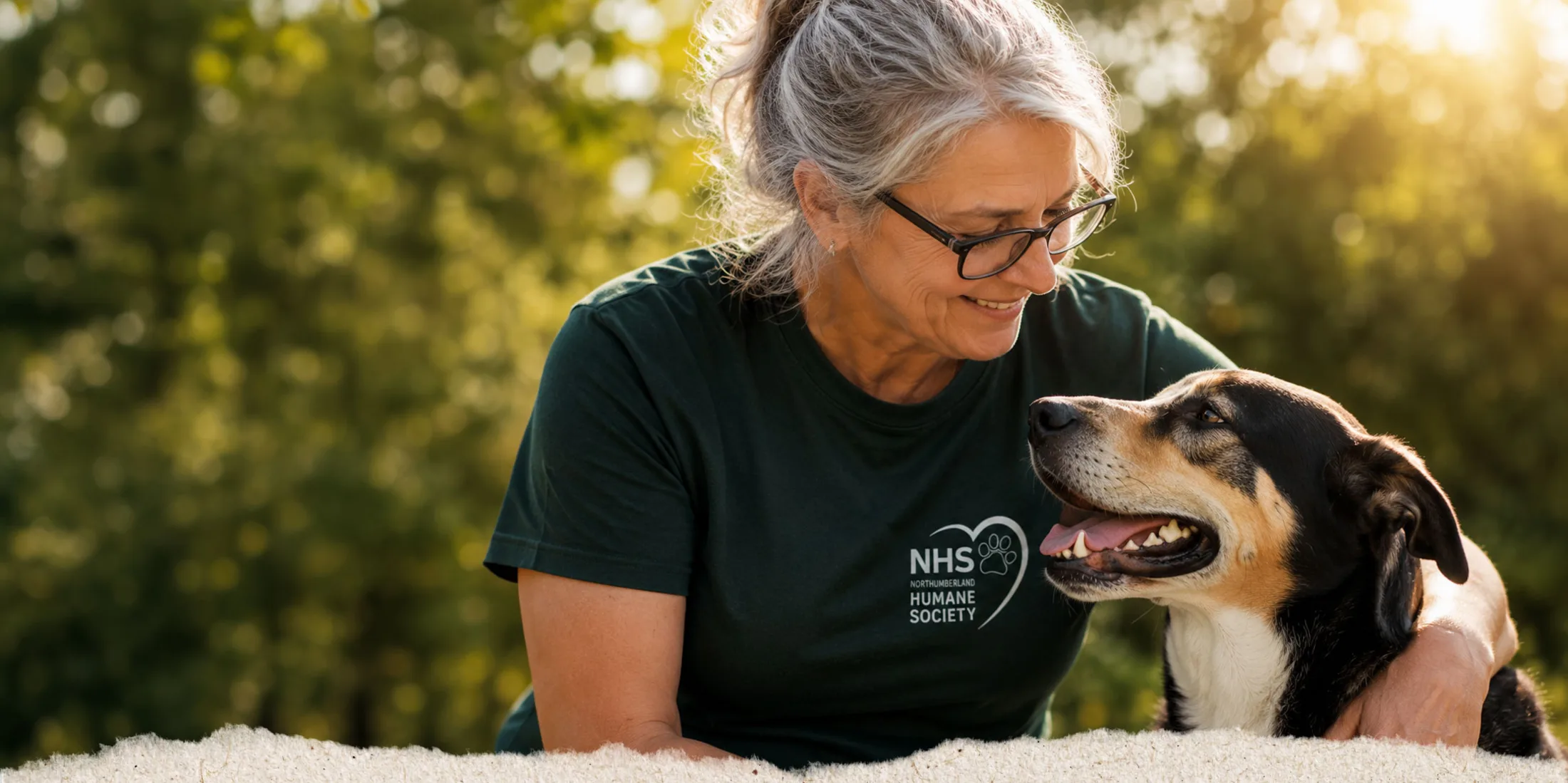 An NHS volunteer sharing a quiet moment with a shelter dog outdoors