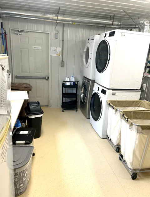 Washers and utility sinks crowded into NHS's shared laundry and sanitation room